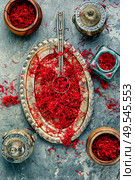 Exotic spice, saffron on a vintage oriental tray. Heap of saffron spice. Стоковое фото, агентство Ingram Publishing / Фотобанк Лори