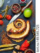 Grilled octopus with roasted vegetables.Traditional mediterranean dish. Grilled octopus on cheese waffle. Стоковое фото, агентство Ingram Publishing / Фотобанк Лори