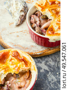 Squid and seafood soup with bread cap.Seafood julienne.. Seafood soup or julienne. Стоковое фото, агентство Ingram Publishing / Фотобанк Лори