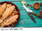 Spicy mullet fish fried with horseradish roots.Asian food. Delicious fried fish. Стоковое фото, агентство Ingram Publishing / Фотобанк Лори