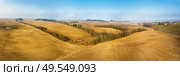 Panorama of empty plowed field in early spring. Beginning of the gardening season, aerial view. Sunny March rural scene. Belarus, Minsk region. Стоковое фото, агентство Ingram Publishing / Фотобанк Лори