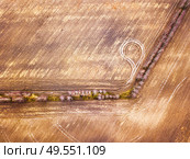 Empty plowed field in early spring. Beginning of the gardening season, top aerial view. Plowed texture. Sunny March rural scene. Belarus, Minsk region. Стоковое фото, агентство Ingram Publishing / Фотобанк Лори