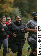 A dynamic scene featuring a group of people sprinting in a competitive race, showcasing determination and athleticism. Стоковое AI-изображение, AI-художник Данила Большаков / Фотобанк Лори
