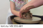 Child hands make earthenware cup working on pottery wheel at workshop. Стоковое видео, видеограф Ирина Старикова / Фотобанк Лори