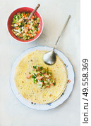 Tortilla wraps sandwiches preparation with tasty fresh avocado salsa salad on white background, top view. Healthy food.  Vegetarian lunch or snack. Стоковое фото, агентство Ingram Publishing / Фотобанк Лори