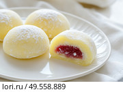 Delicious Japanese moti desserts. Close up. Asian rice daifuku dessert sweet mochi. Cut in half with filling. Traditional dessert mochi ice cream. Colorful rice cake. Fukashi manju. Culinary delights. Стоковое AI-изображение, AI-художник Марина Демидюк / Фотобанк Лори