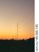 Electrical pylons at dawn in a beautiful sunset with a clear sky. Стоковое фото, агентство Ingram Publishing / Фотобанк Лори
