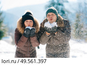 boy and girl outdoors on a winter walk playing snowballs and sledding. Стоковое фото, агентство Ingram Publishing / Фотобанк Лори