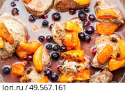 Baked pork in red wine with apricot and blackcurrant.. Stew meat with apricot. Стоковое фото, агентство Ingram Publishing / Фотобанк Лори