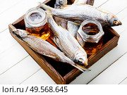 Dried fish on the table,salty dry sea fish for beer. Beer and dried fish. Стоковое фото, агентство Ingram Publishing / Фотобанк Лори
