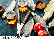 Dried fish on the table,salty dry sea fish for beer. Beer and dried fish. Стоковое фото, агентство Ingram Publishing / Фотобанк Лори
