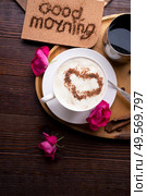 porcelain cup of coffee with ice cream and cinnamon heart served  at black wooden table. Стоковое фото, агентство Ingram Publishing / Фотобанк Лори