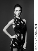 white girl modell on a dark background in a dress made of cut stripes of black fabric. Стоковое фото, агентство Ingram Publishing / Фотобанк Лори