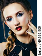 white girl modell on a dark background in a dress made of cut stripes of black fabric. Стоковое фото, агентство Ingram Publishing / Фотобанк Лори