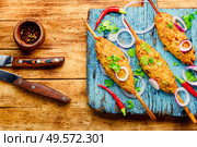 Juicy lula kebab made on wooden board.Minced meat on the grill. Lula kebab on stick. Стоковое фото, агентство Ingram Publishing / Фотобанк Лори