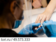 Aesthetician doing the manicure, filing the nails with a file to his client in a beauty center. Business and beauty concepts. Aesthetician doing the manicure, filing the nails with a file to his client in a beauty center. Стоковое фото, агентство Ingram Publishing / Фотобанк Лори