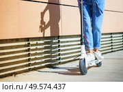 Detail of woman circulating in the city with an electric scooter. Woman circulating in the city with an electric scooter. Стоковое фото, агентство Ingram Publishing / Фотобанк Лори