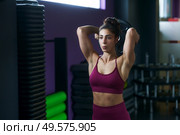 Athletic woman doing triceps push-ups with a barbell plate at the gym.. Athletic woman doing triceps push-ups with a barbell plate. Стоковое фото, агентство Ingram Publishing / Фотобанк Лори