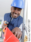 builder with cordless power tool reaching for screws. Стоковое фото, агентство Ingram Publishing / Фотобанк Лори