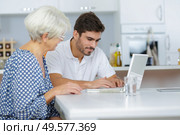 young man teaches her grandmother to work on the computer. Стоковое фото, агентство Ingram Publishing / Фотобанк Лори