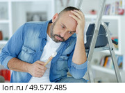 mature man fed up with painting in his house. Стоковое фото, агентство Ingram Publishing / Фотобанк Лори