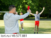 referee hands with red card on football field. Стоковое фото, агентство Ingram Publishing / Фотобанк Лори