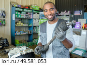 delighted man holding spare part. Стоковое фото, агентство Ingram Publishing / Фотобанк Лори