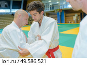 Two men competing at judo. Стоковое фото, агентство Ingram Publishing / Фотобанк Лори