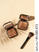 Minimal modern cosmetic scene with make up brushe, bronzer and palm shadow overlay, top view. make up brushes. Стоковое фото, агентство Ingram Publishing / Фотобанк Лори