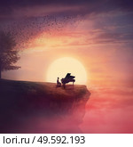Musician sings and plays a piano song on the edge of a cliff over sunset sky, with a tree scattering leaves in the wind. Surreal and inspirational scene above clouds. Adventure and musical concept. Стоковое фото, агентство Ingram Publishing / Фотобанк Лори