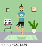 Man practicing yoga at home. Meditation pose, young guy with ponytail meditate standing at one leg at carpet. Keep calm. Music center, houseplant, pictures at wall. Qurantine isolation. Stay at home. Man practicing yoga, meditation pose, young guy with ponytail meditate standing at one leg. Стоковая иллюстрация, агентство Ingram Publishing / Фотобанк Лори