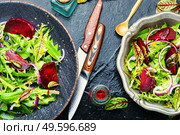 Fresh healthy dandelion, sorrel and beetroot salad on stone table. Spring greens and beetroot salad,mixed herbs. Стоковое фото, агентство Ingram Publishing / Фотобанк Лори