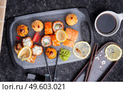 sushi roll set served at grey tray at black table. flat lay. close up. Стоковое фото, агентство Ingram Publishing / Фотобанк Лори