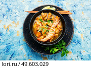 Tom yam kung spicy thai seafood soup in bowl. Tom yum soup with seafood and coconut milk. Стоковое фото, агентство Ingram Publishing / Фотобанк Лори