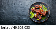 Tasty BBQ beef ribs seasoned with spicy sauce.Space for text. Roasted beef brisket on the ribs,copy space. Стоковое фото, агентство Ingram Publishing / Фотобанк Лори