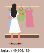 Girl chooses clothes on the hanger on shopping. Female buyer is selecting clothes in a store. Young beautiful fashion girl is standing near the stand with clothes. Shopper during the sale in a shop. Girl chooses clothes on the hanger on shopping. Female buyer is selecting clothes in a store. Стоковая иллюстрация, агентство Ingram Publishing / Фотобанк Лори