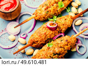 Traditional lula kebab on a wooden skewer. Lamb dish. Eastern cuisine. lula kebab on a skewer. Стоковое фото, агентство Ingram Publishing / Фотобанк Лори