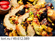 Baked pork with dates, apples and pistachios. Roasted lean pork.. Meatloaf with dates and apples. Стоковое фото, агентство Ingram Publishing / Фотобанк Лори
