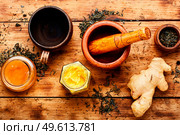 Teapot with tea made from ginger,honey and lemon.Vitamin, healing tea. Healing tea with ginger. Стоковое фото, агентство Ingram Publishing / Фотобанк Лори