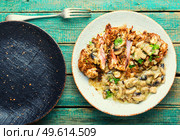 Turkey meat in cheese breading with mushroom sauce on wooden background. Turkey schnitzel with fried mushrooms. Стоковое фото, агентство Ingram Publishing / Фотобанк Лори