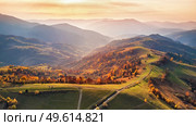 Beautiful mountain autumn landscape with meadow and colorful forest. Red, Yellow, Orange trees on hillsides. National Natural Park Synevyr, Carpathians, Ukraine, Europe. Стоковое фото, агентство Ingram Publishing / Фотобанк Лори