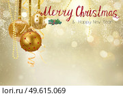 Golden christmas balls garland and evergreen fir tree on glowing golden background with copy space. Golden christmas balls. Стоковое фото, агентство Ingram Publishing / Фотобанк Лори