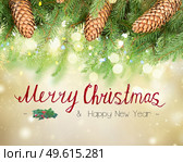 Pine branch with cones border with lights bokeh with merry christmas greetings. Christmas tree with lights. Стоковое фото, агентство Ingram Publishing / Фотобанк Лори