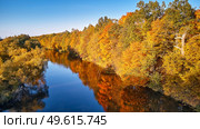 Idyllic autumn sunny landscape, rural aerial scene - stock photo. Fall colorful trees reflecting in water, picturesque background. Wild forest, river, meadow sunset panorama, Belarus. Стоковое фото, агентство Ingram Publishing / Фотобанк Лори