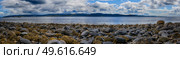 Panoramic view of rocks and boulders on the shore of the Firth of Clyde on the West coast of Scotland. Стоковое фото, агентство Ingram Publishing / Фотобанк Лори