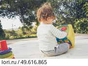 Backview of a baby playing in nature. Стоковое фото, агентство Ingram Publishing / Фотобанк Лори