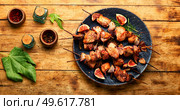 Fried chicken meat on skewers.Chicken kebab with figs on rustic wooden surface. BBQ with chicken and figs,wooden surface. Стоковое фото, агентство Ingram Publishing / Фотобанк Лори