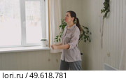 Brunette woman dance, have fun at home listens song, moves to music, feels overjoyed, celebrate good news, relish carefree life looks happy. Young adult female twirls, grooves. Lady dancing in kitchen. Стоковое видео, видеограф Марина Демидюк / Фотобанк Лори