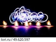 fiery pieces of a fire show against a dark sky and thunderstorms. Стоковое фото, агентство Ingram Publishing / Фотобанк Лори