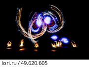 fiery pieces of a fire show against a dark sky and thunderstorms. Стоковое фото, агентство Ingram Publishing / Фотобанк Лори